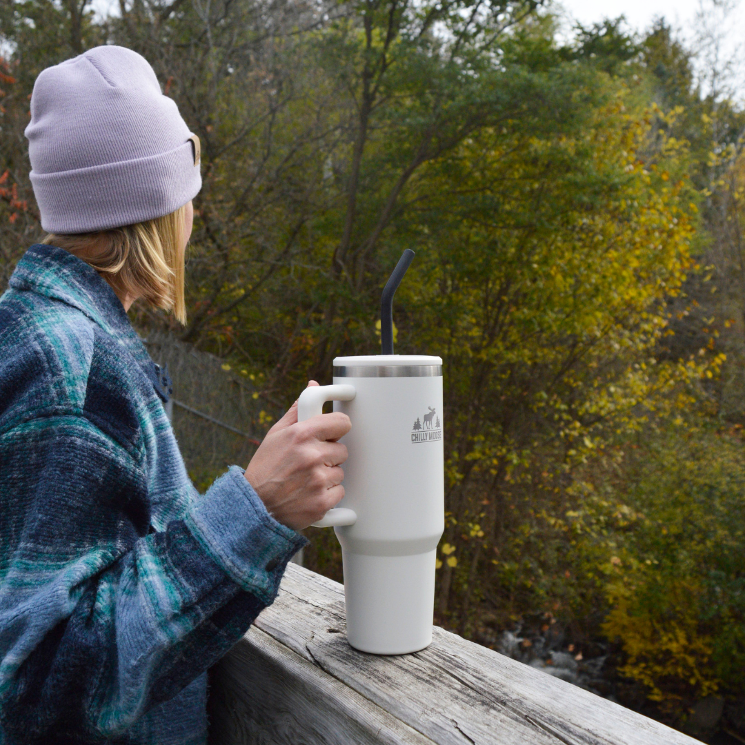 Classic Summerhill 40oz Tumbler on a deck rail overlooking the lake in summer