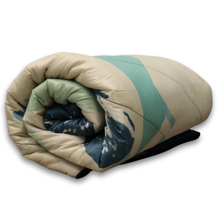 Stillwater Ultralight Puffy Blanket – Chilly Moose – Rolled showing reversible navy/cream, quilted texture #colour_tofino