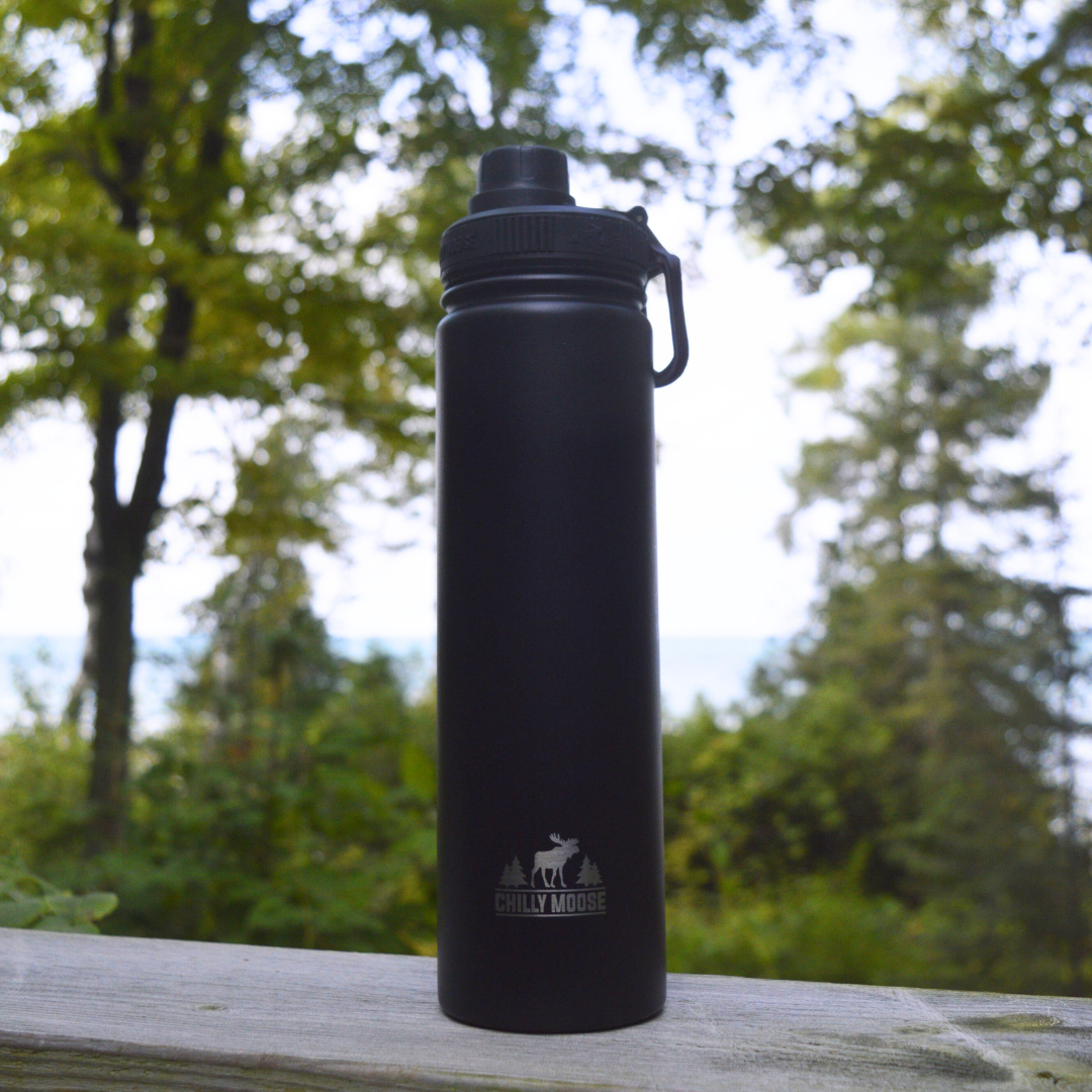 Curling Canada Scotties Bottle – Chilly Moose – Black bottle outdoors with trees, on railing #colour_black