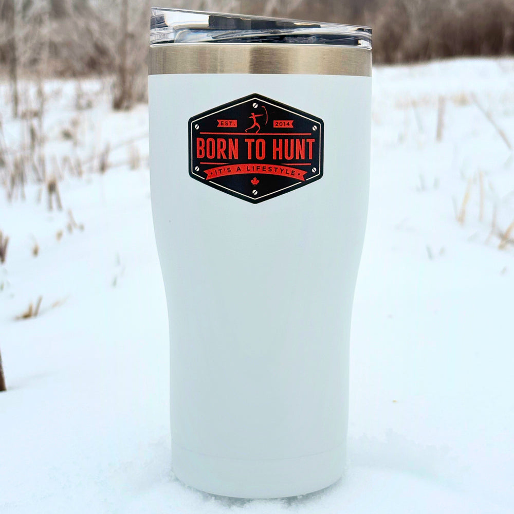 White insulated tumbler with 'Born to Hunt' logo in a snowy outdoor setting #colour_frost-white