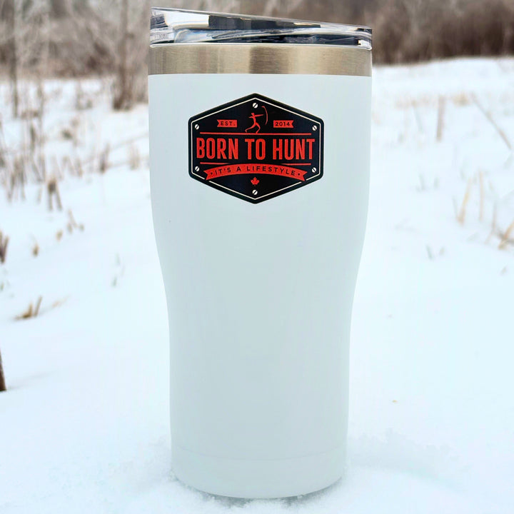 White insulated tumbler with 'Born to Hunt' logo in a snowy outdoor setting #colour_frost-white