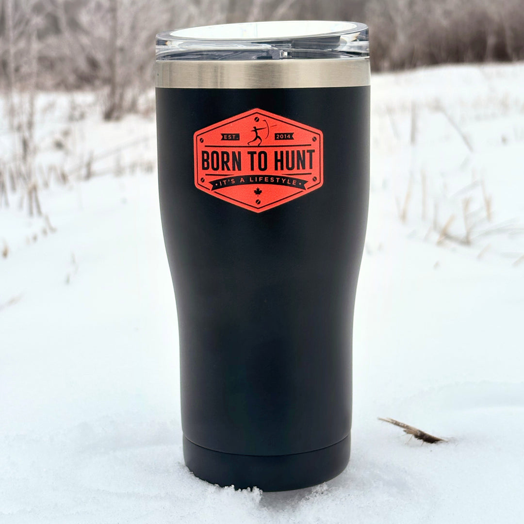 Black insulated tumbler with a red label in a snowy landscape #colour_midnight