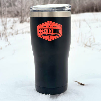 Black insulated tumbler with a red label in a snowy landscape #colour_midnight