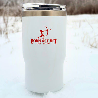 White insulated tumbler with 'Born to Hunt' logo in the snow #colour_frost-white