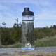 28oz Clearwater Canteen in Clear – Chilly Moose – lifestyle on wooden dock with outdoor background #colour_clear