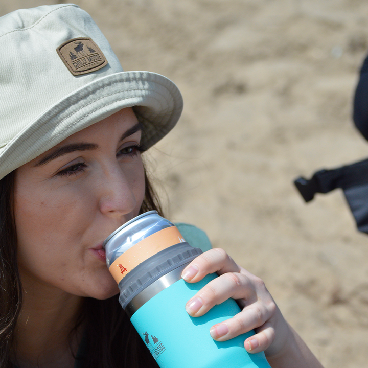 Harbour Hat – Chilly Moose – Beige bucket hat worn at beach with tumbler #colour_sand-beige