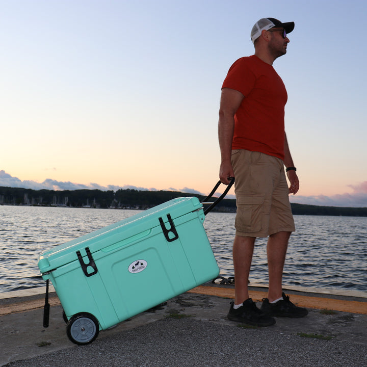 75L Wheeled Explorer Open Box – Chilly Moose – Lifestyle at lake with person pulling cooler at sunset