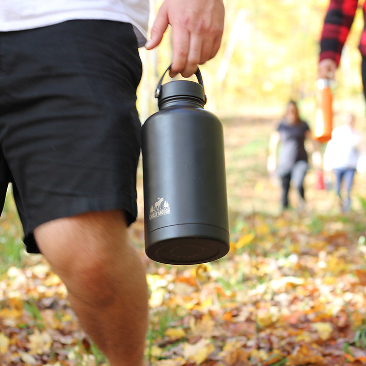 Portage Growler 64oz – Chilly Moose – Lifestyle in Hand Outdoor Fall Scene