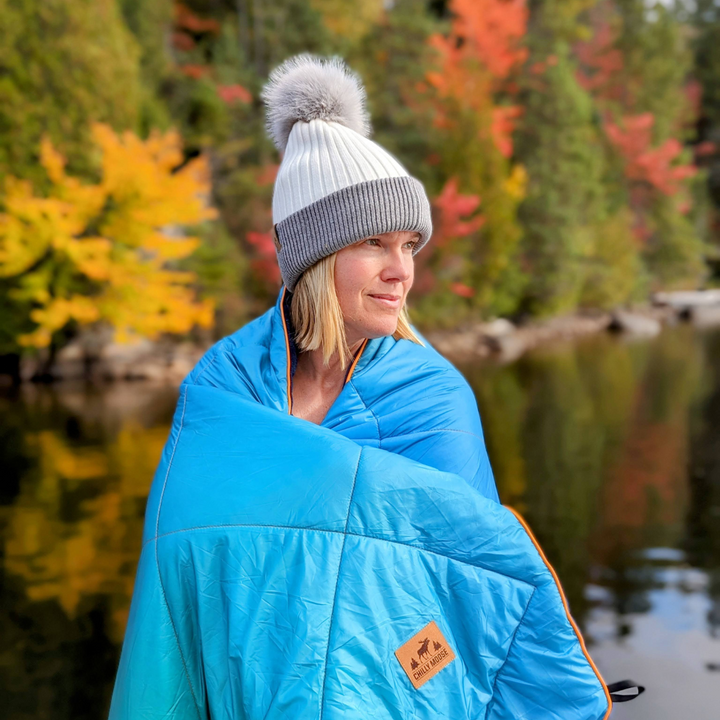 Ski Bunny Toque in White/Grey – Chilly Moose – Worn lakeside with Rocky blanket in blue #colour_white